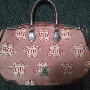 Dooney and Bourke red monogrammed satchel. Good condition